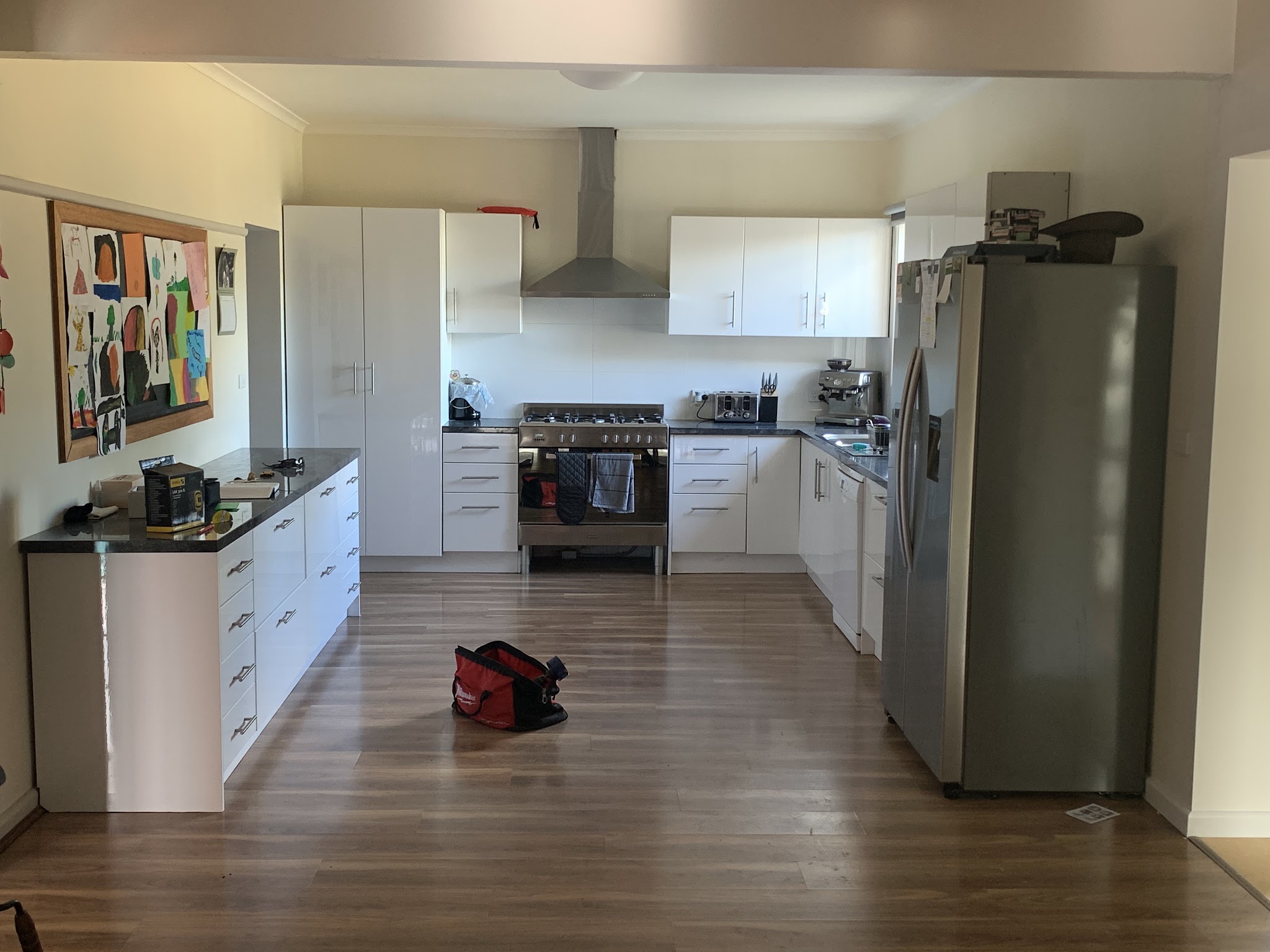 Finished kitchen with downlights, rangehood and appliances installed